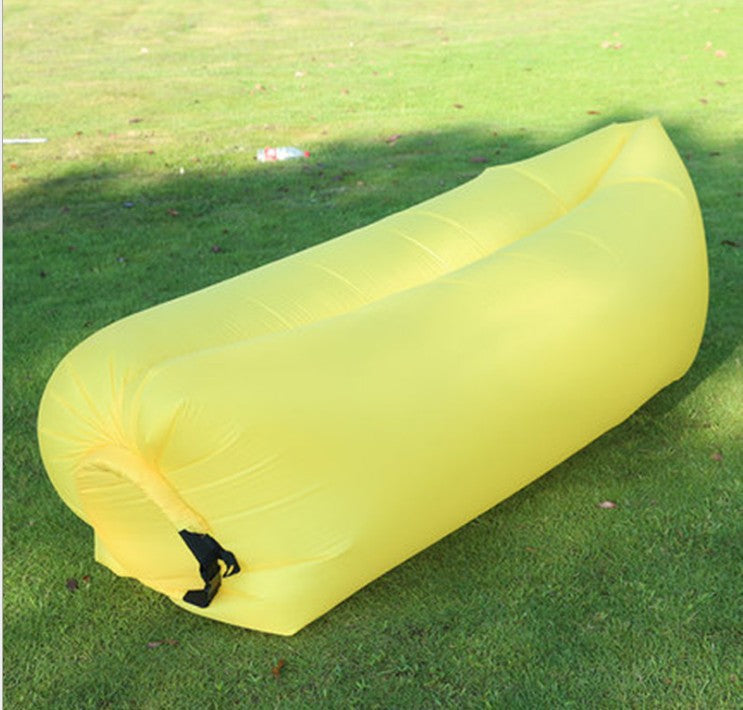 Yellow inflatable sofa on a grassy field