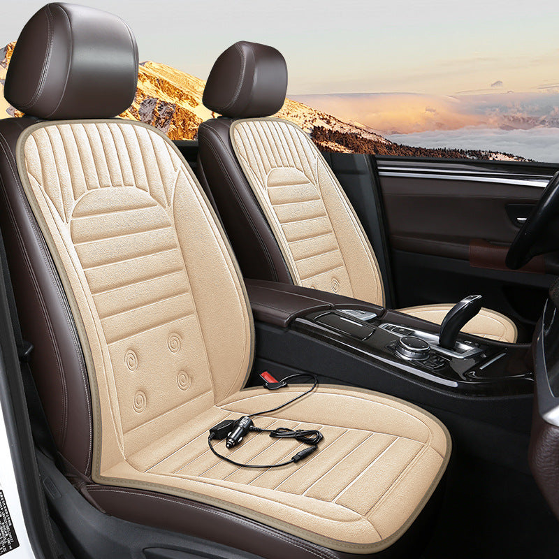 Car interior with beige and brown heated seat covers and a scenic view outside the window.
