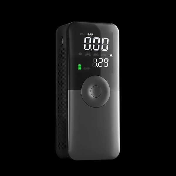Black portable air pump with digital display on a black background
